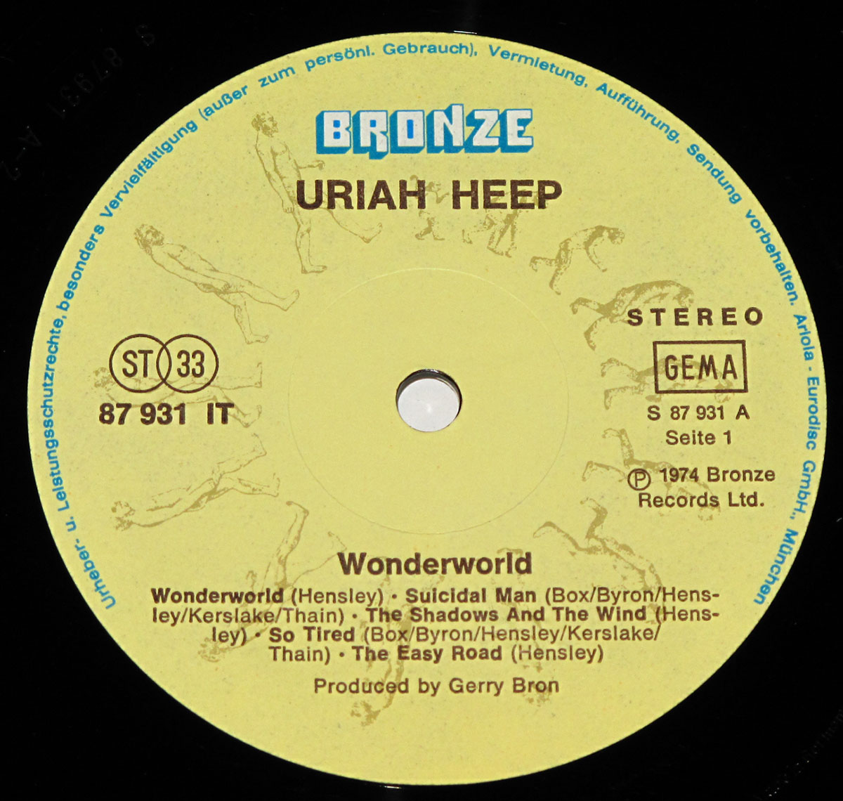 Close-up of the Side 1 label on Uriah Heep's 'Wonderworld' vinyl LP, featuring the Bronze Records logo, tracklist, and evolution-inspired artwork in a beige and brown color scheme.